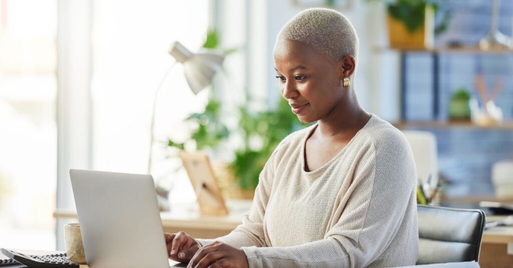 Person at computer learning about resume mistakes from Addison Group